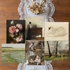 Collage of various paintings on a wooden surface with lace doilies.