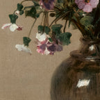 Cup and saucer with flowers and a vase on a wooden surface