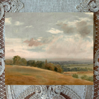 Landscape painting with a textured border and lace overlay