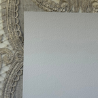 Textured paper with decorative lace border